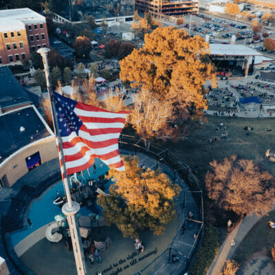 Aerial photo of Elmwood Park in fall, with American flag in foreground