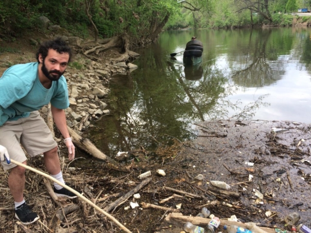 Volunteer cleaning Roanoke River debris
