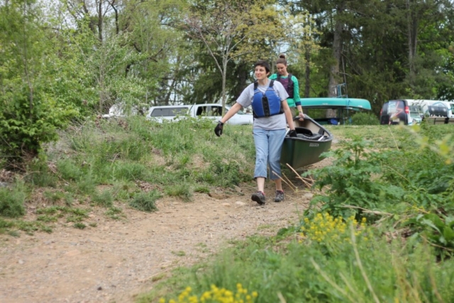 Volunteers Carry a Canoe in Wasena Park