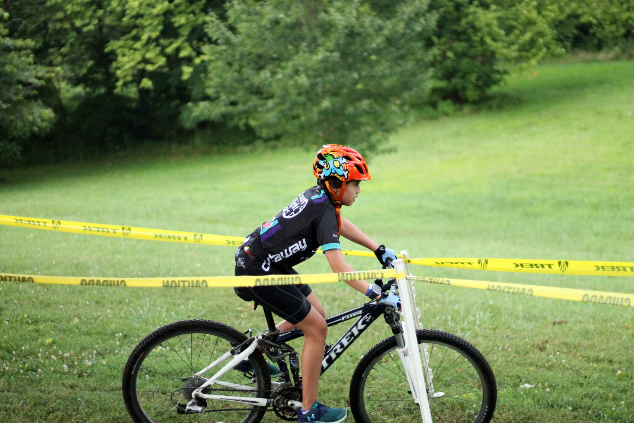 Fishburn youth mountain biker rides around a turn