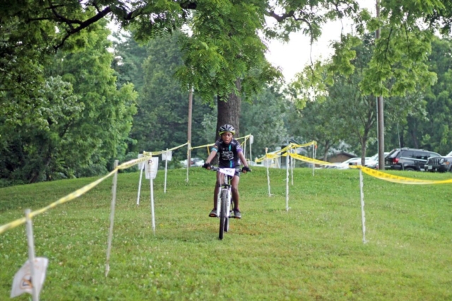 Fishburn youth mountain biker rides down straightaway toward the hill