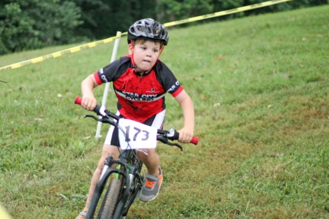 Fishburn youth mountain biker rides out of a turn heading for the finish line