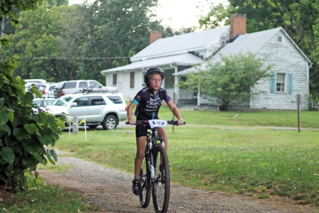 Fishburn youth mountain biker rides across gravel at the Roanoke Parks and Recreation race event