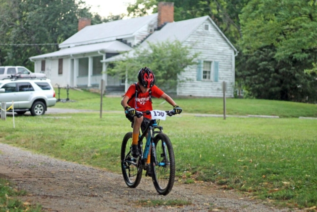 Fishburn youth mountain biker rides across gravel at the Play Roanoke race event