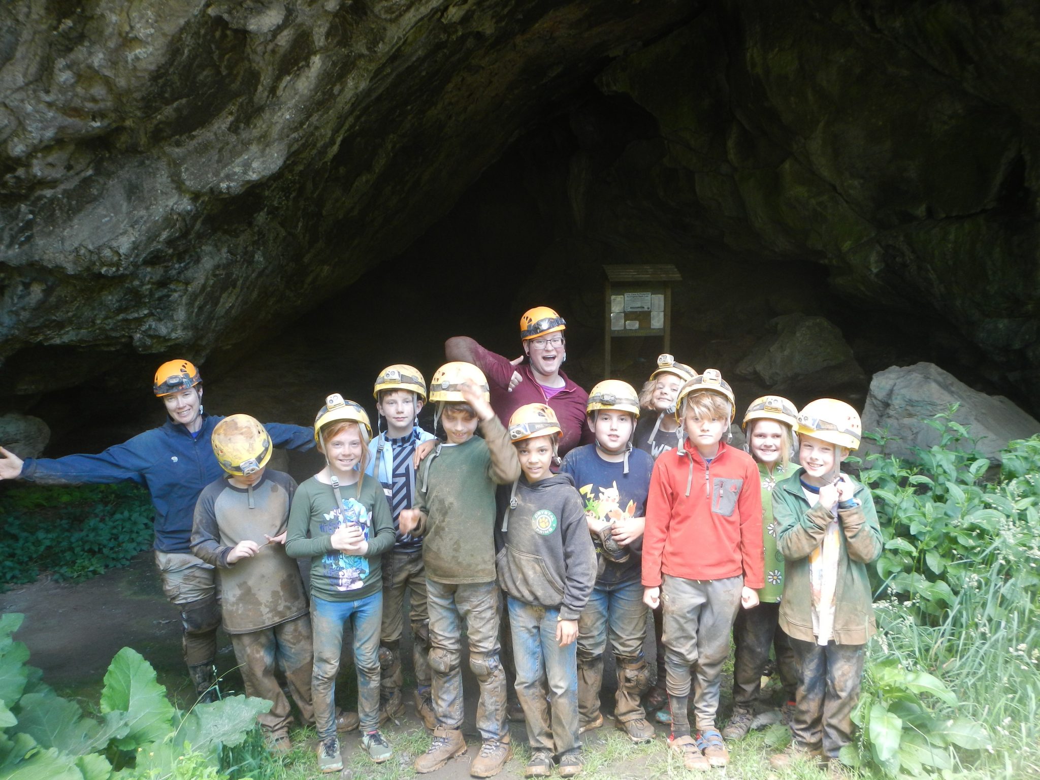 Muddy kids smiling after caving