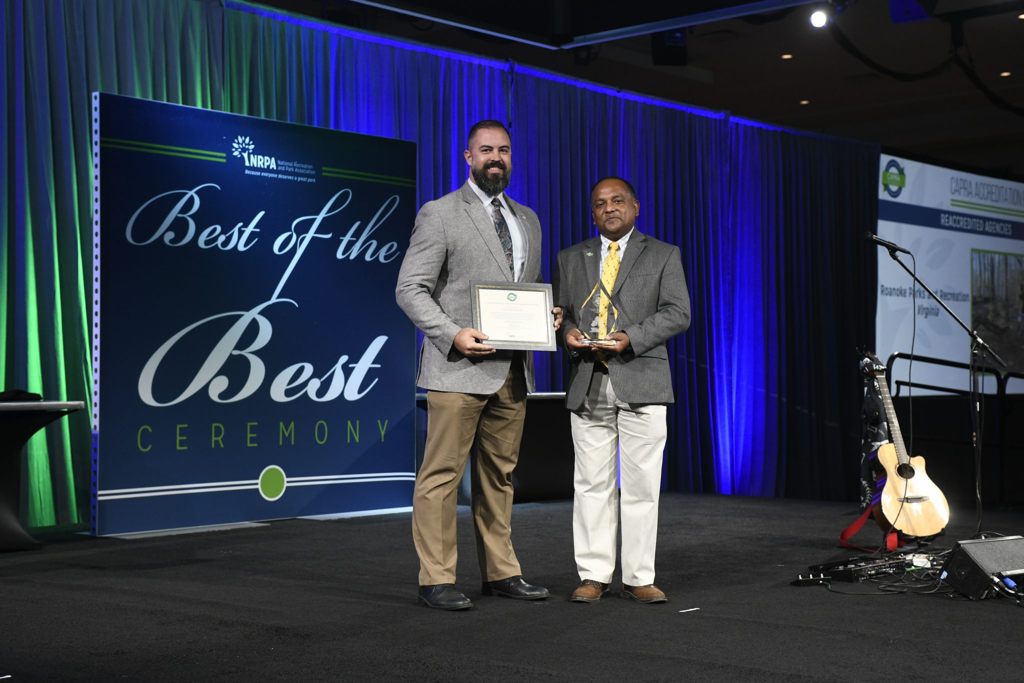 Michael Clark (left), Director of Roanoke Parks and Recreation, accepts re-accreditation award at NRPA conference in Indianapolis, Indiana.