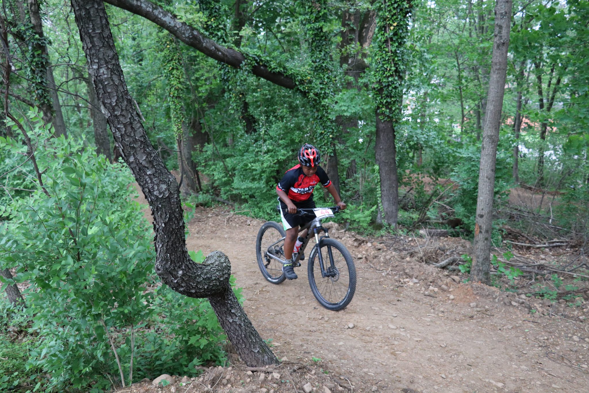 Young African-American man cycling on a mountain bike trail