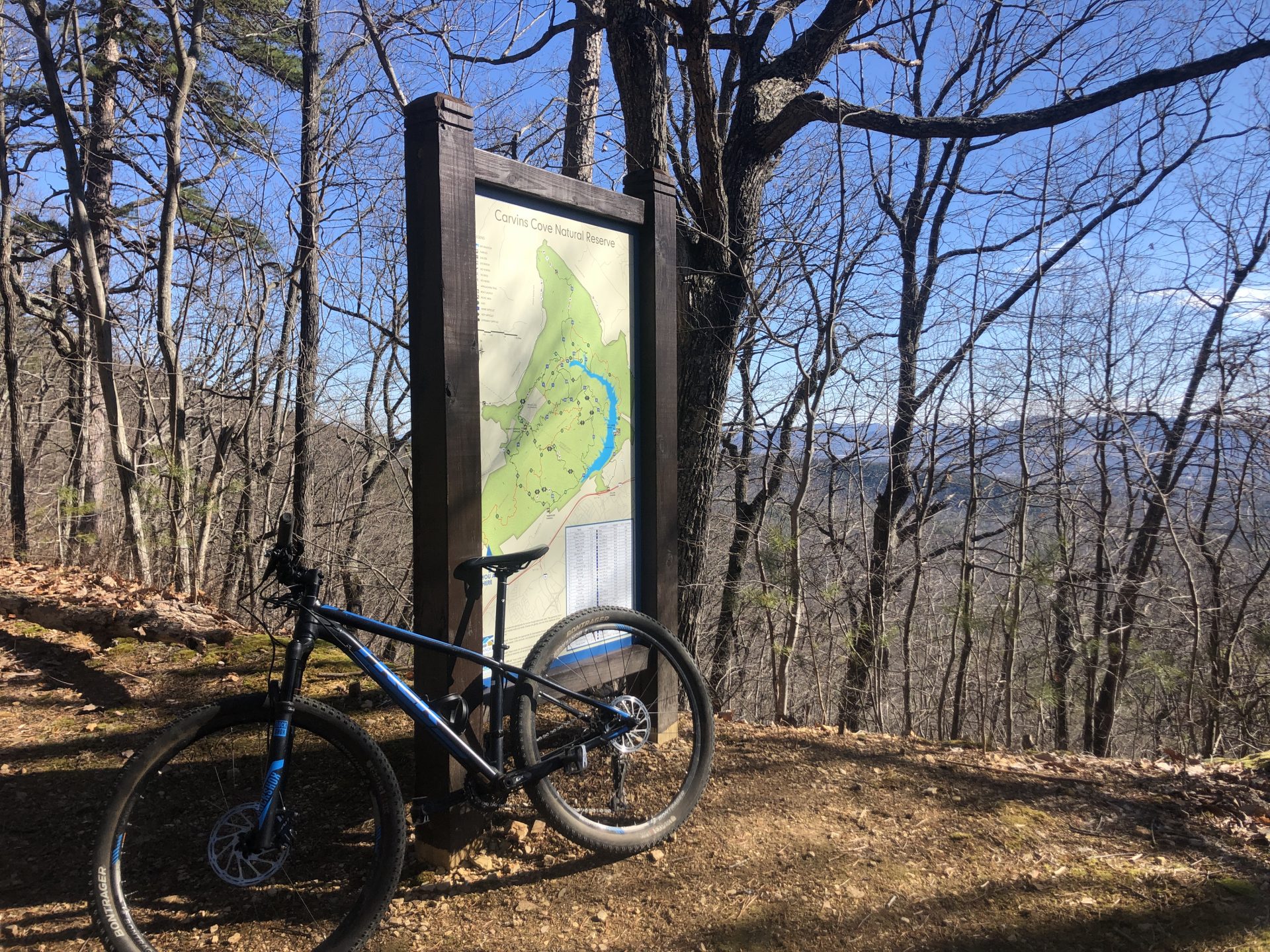 Mountain Bike on a trail leaned against a trail sign