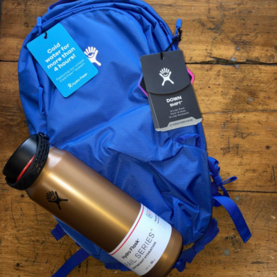 Hydroflask gold water bottle and blue Hydroflask pack