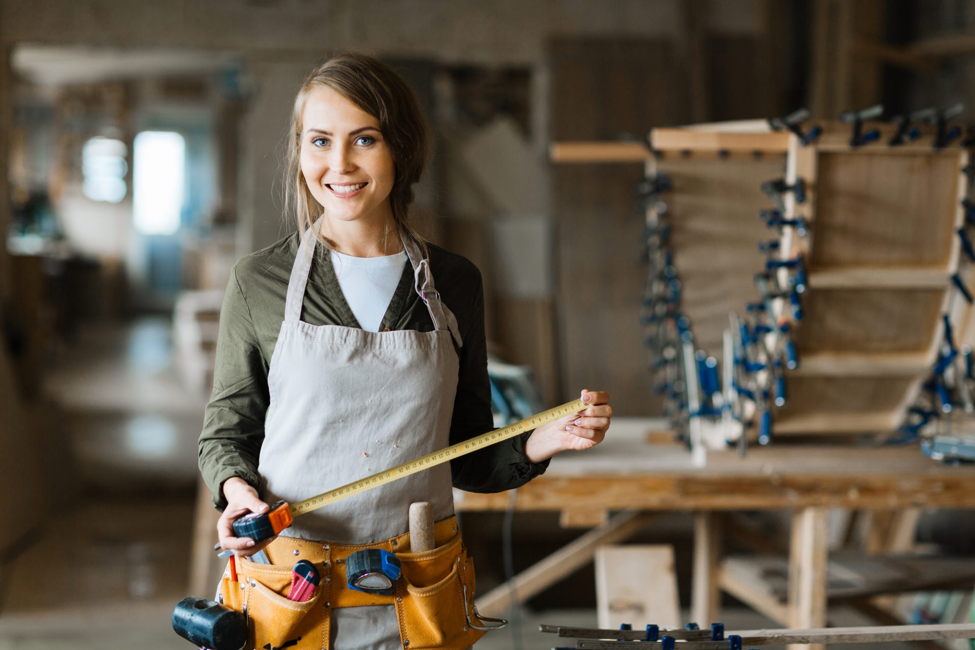 Young woman with tools and tool belt
