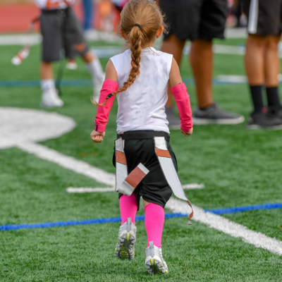 Young girl playing flag football