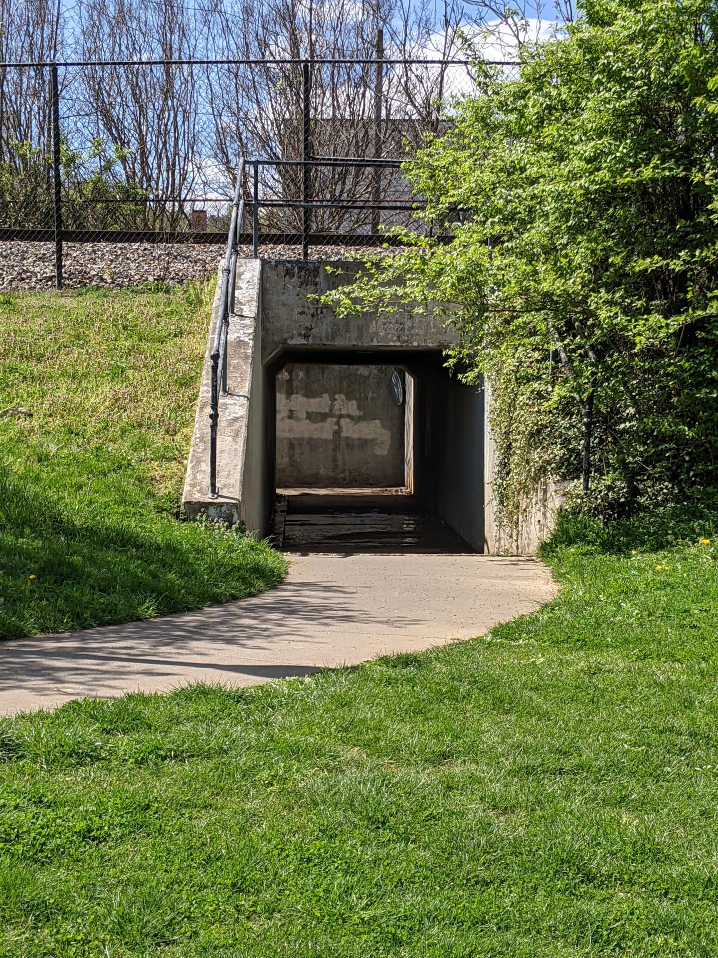 sidewalk leading to a tunnel during the day