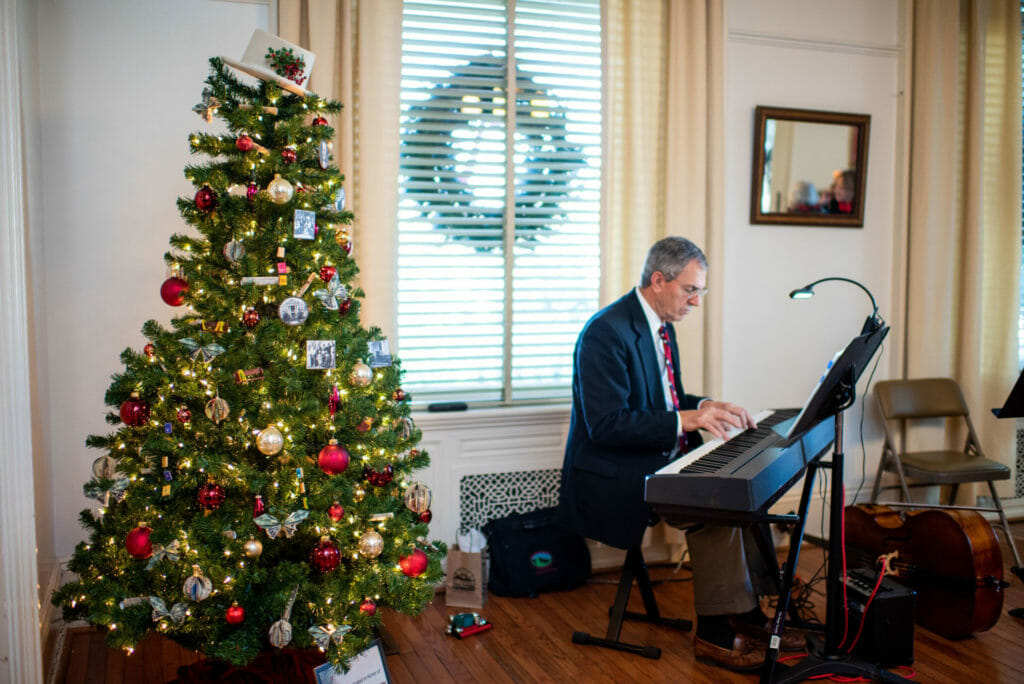 piano player and christmas tree