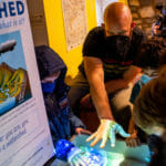 Children play with Augmented Reality Sandbox