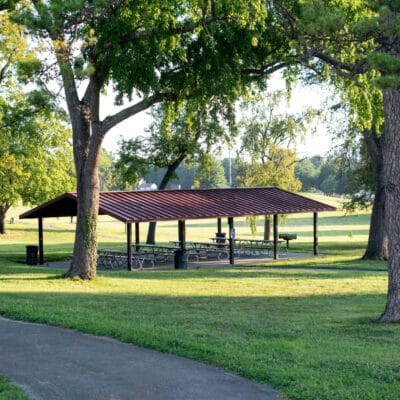 McCadden Park Park shelter with picnic tables surrounded by large shade trees