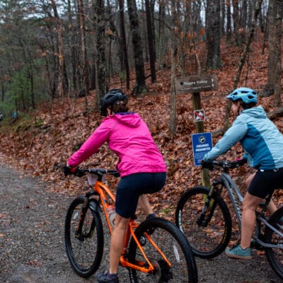 Happy Valley Grit gravel race at Carvins Cove Two mountain bikers ride a fire road at Carvins Cove