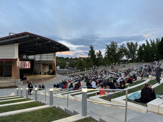 Kids to Parks movie Large crowd in Elmwood Park's ampitheater watch a movie on the big screen at dusk.