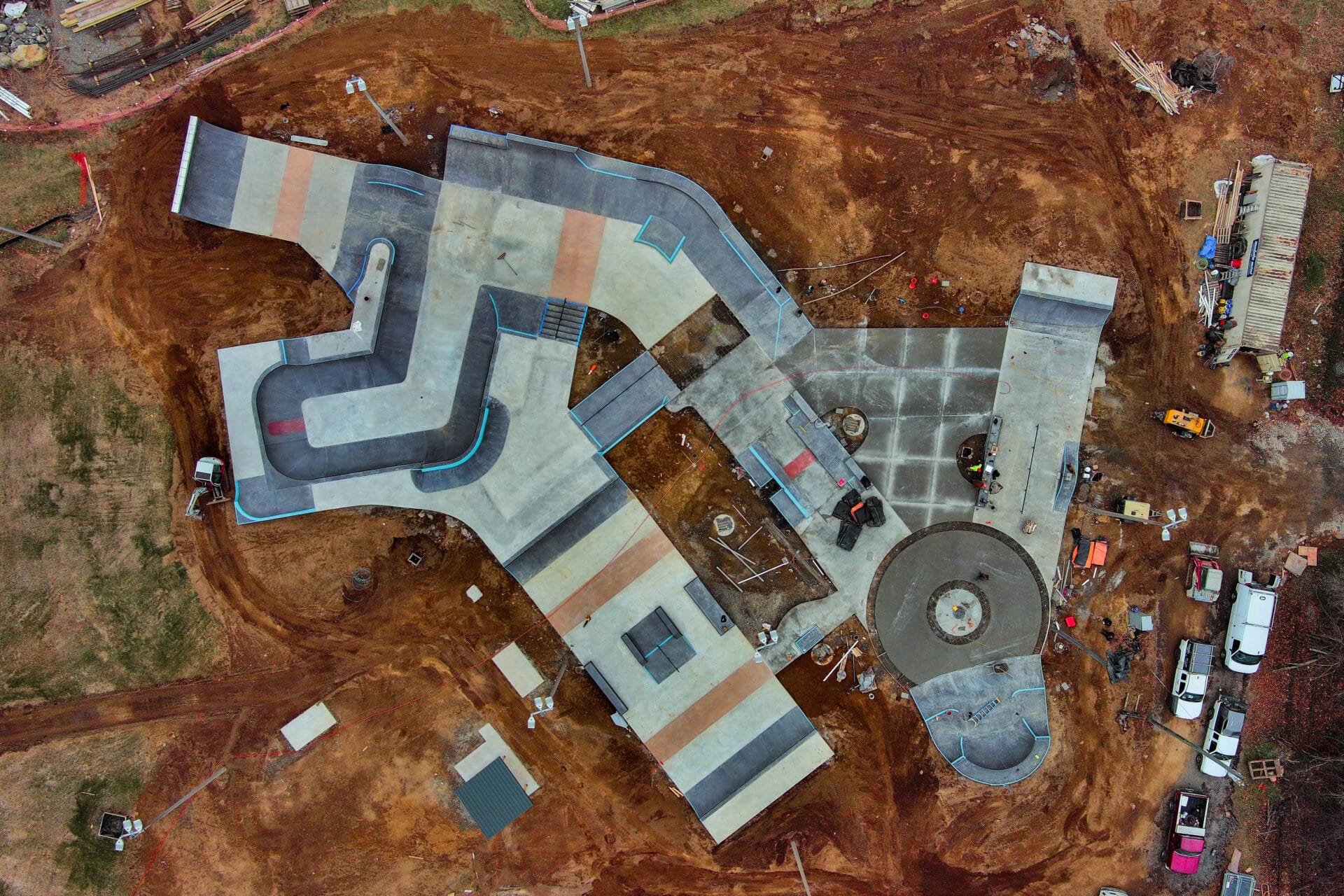 Aerial view of a large street style skatepark near the end of construction.
