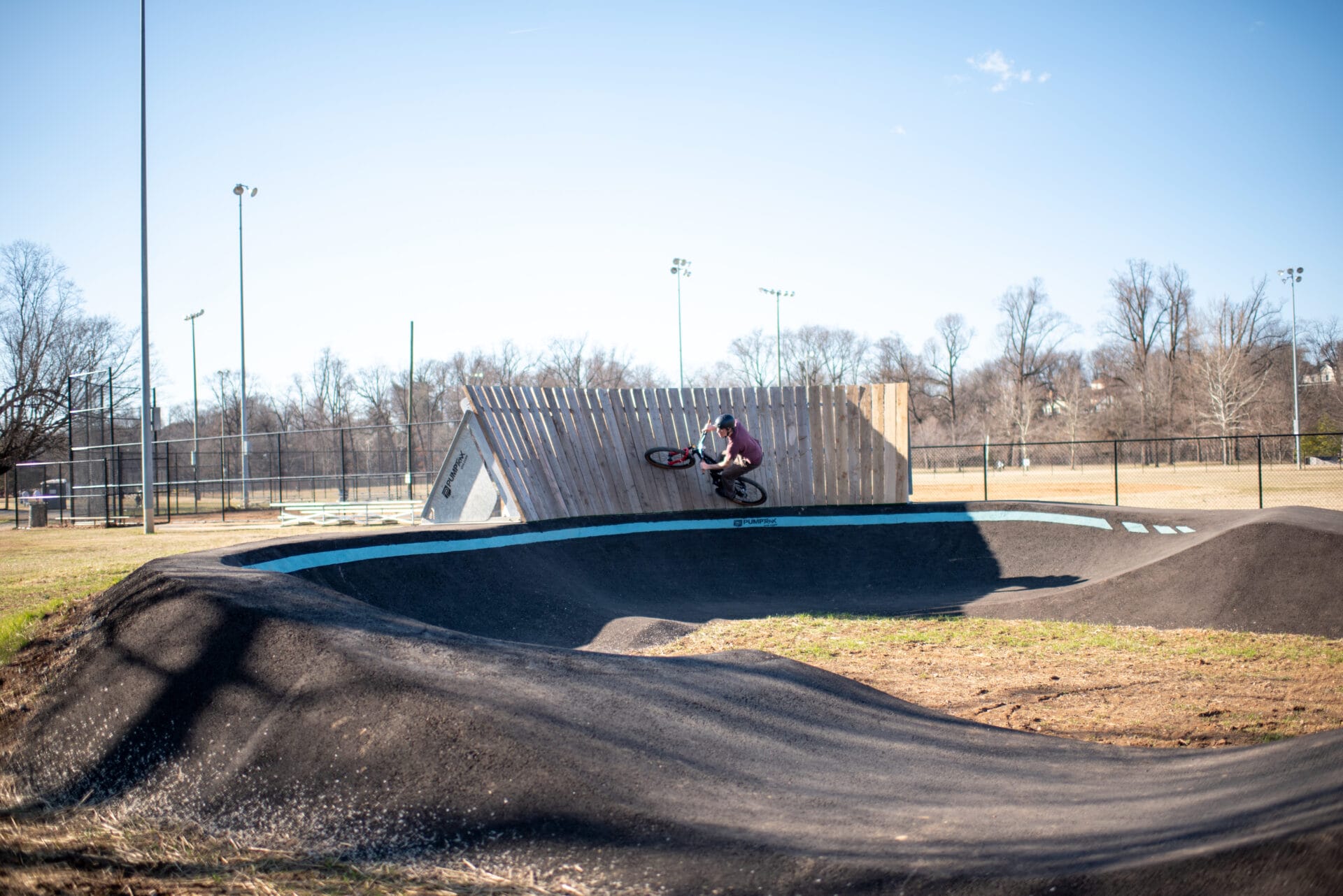 A biker rides up on a wall at the pump track in Roanoke, Virginia.