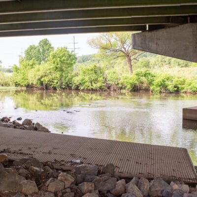 Ramp leading into a river at an underpass.