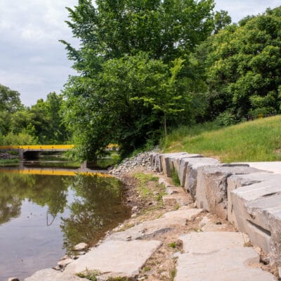 Large stonework along the shoreline of a river.