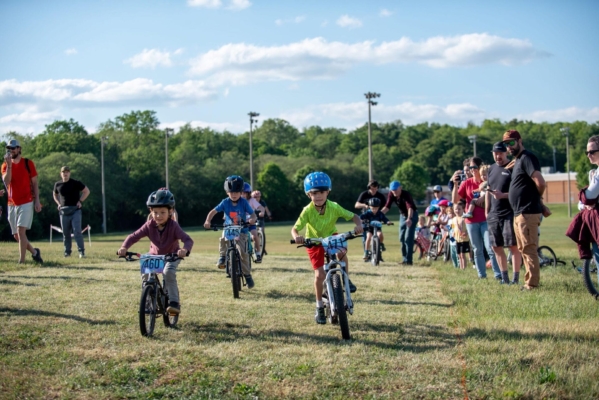 Youth MTB race A group of young mountain bikers compete in a race at a city park.