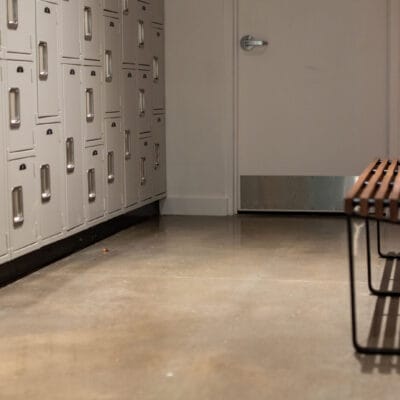 Wooden bench beside a bank of lockers.