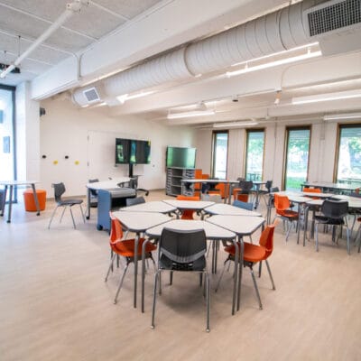 Classroom at an after school program with large windows and colorful modern furnishing.