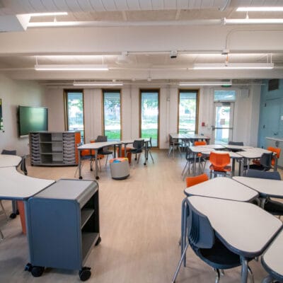 Classroom at an after school program with large windows and colorful modern furnishing.
