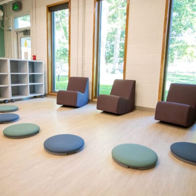 Classroom at an after school program with large windows and colorful modern furnishing.