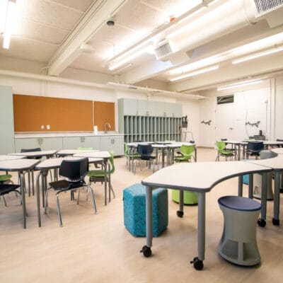 Classroom at an after school program with large windows and colorful modern furnishing.