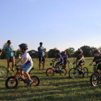 Youth Bike Race A group of young mountain bikers compete in a race at a city park.