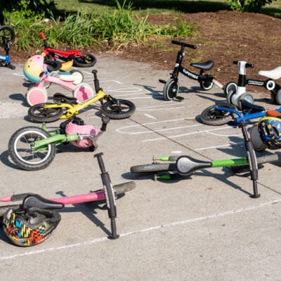 TinyTotTri26 849web A group of children's bikes is staged in a park as part of a 'triathlon' event for toddlers and young children.
