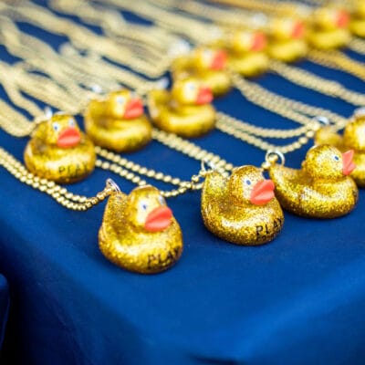 TinyTotTri26 861web Glittery rubber ducky prizes are arranged on a table as awards for a toddler 'triathlon' event.