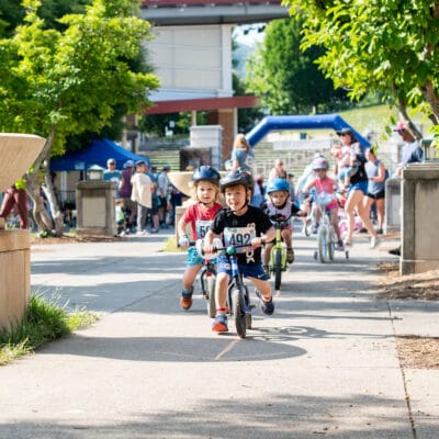 TinyTotTri26 868web Children ride bikes as part of a 'triathlon' event for toddlers and small children.